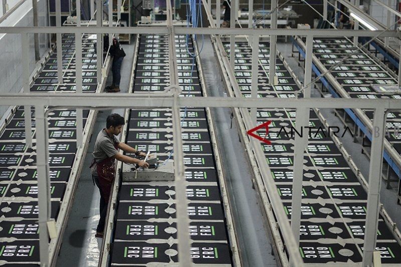 A worker inspects a printed shirt at a clothing factory in Bandung, West Java.